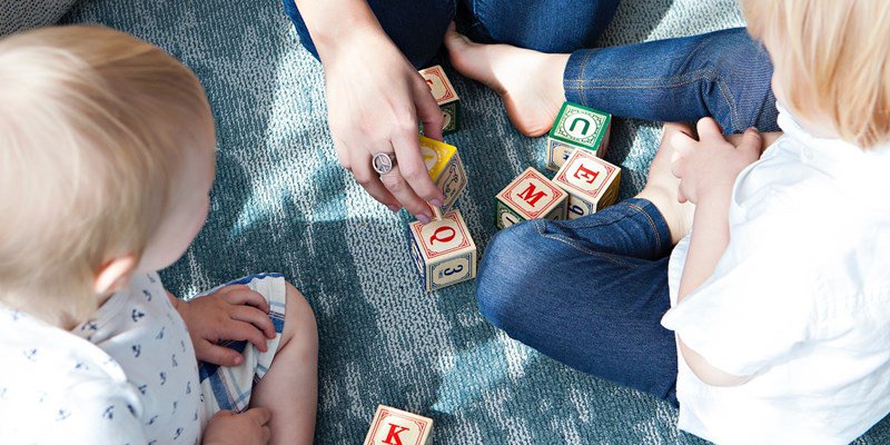 family playing with letter blocks