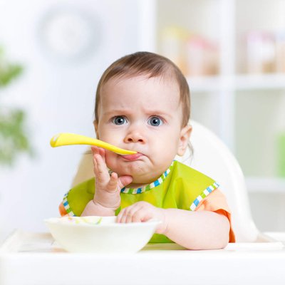 funny-baby-eating-food-on-kitchen.jpg